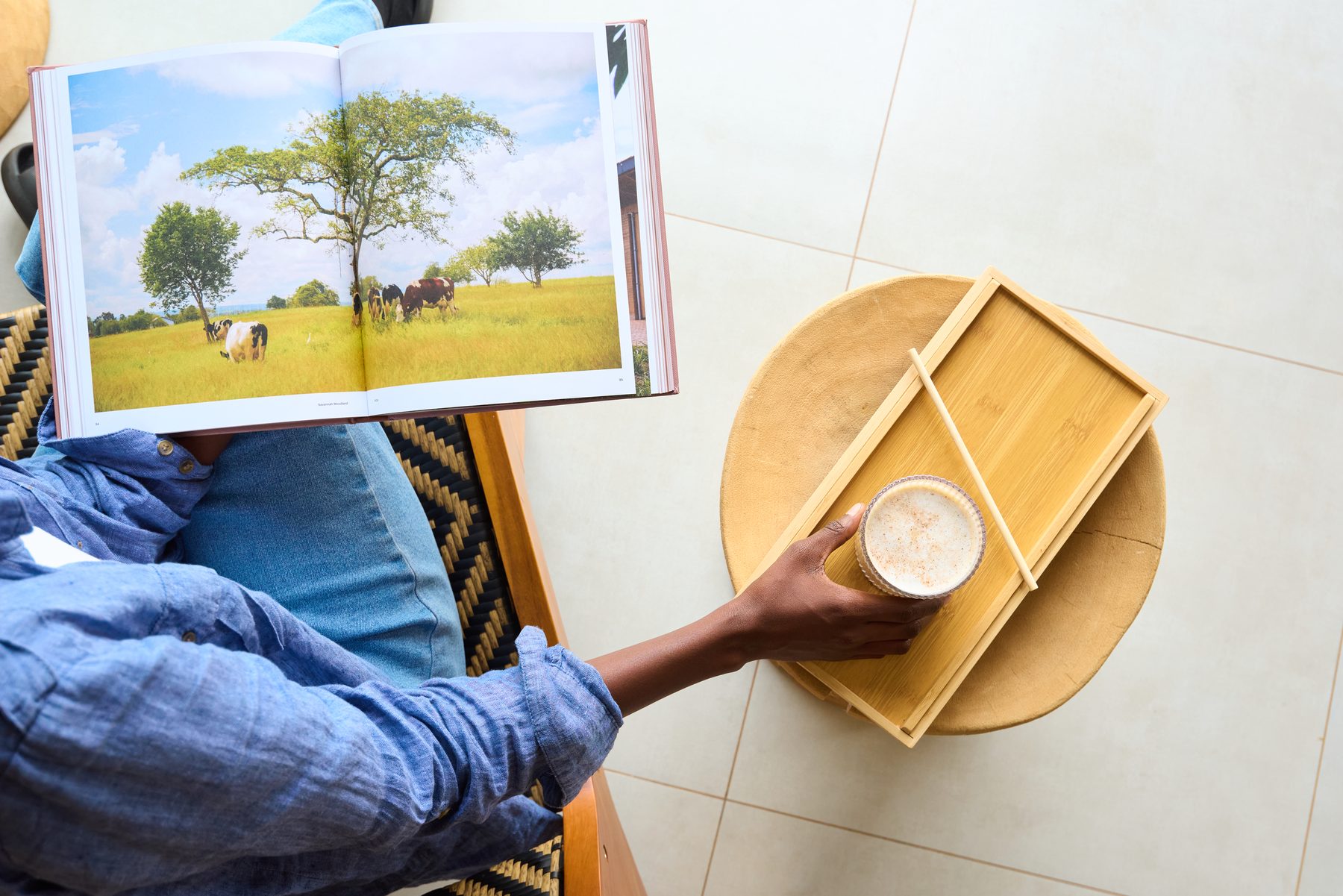 Coffee table book on Rwandan landscapes with a latte