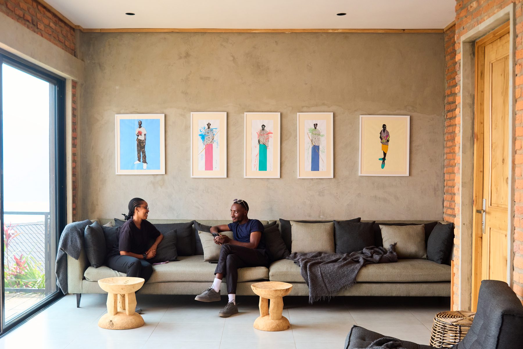 Art gallery wall inside ŌMEKA with African portrait prints