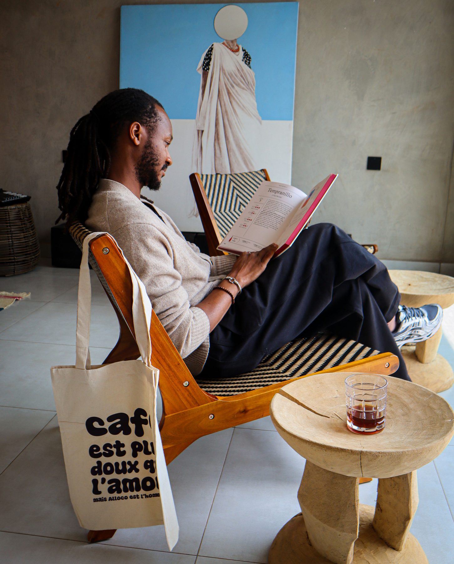 Guest relaxing in a lounge chair reading a wine guide