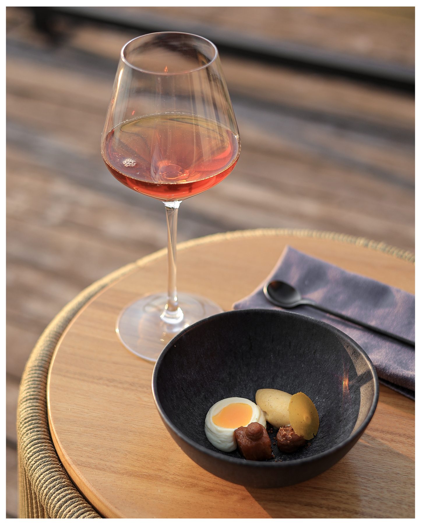 Rosé wine and a curated tasting plate at ŌMEKA